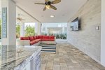 Outdoor living room with large flat screen tv